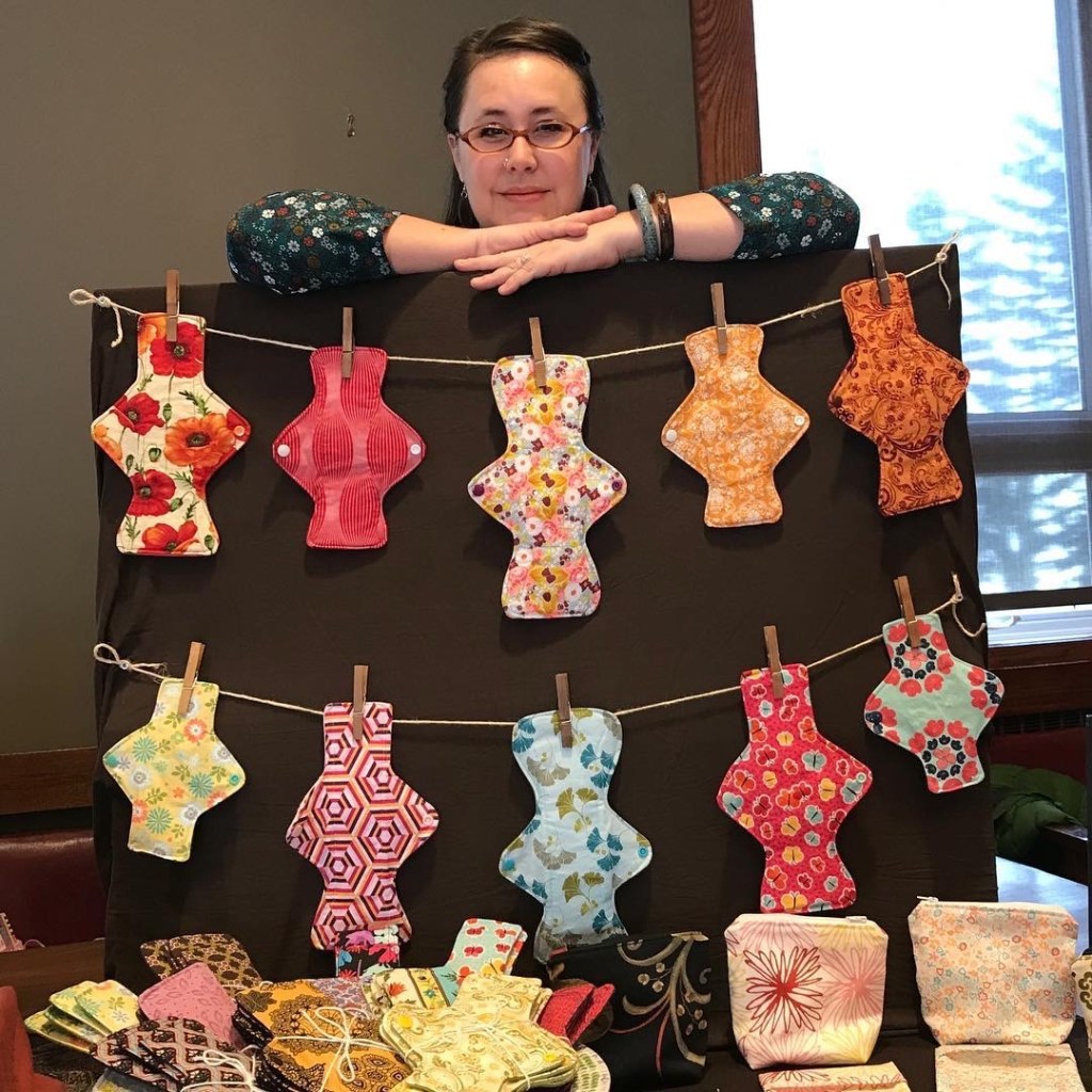 Natalie standing behind her products